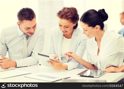 smiling business team working with tablet pcs in office