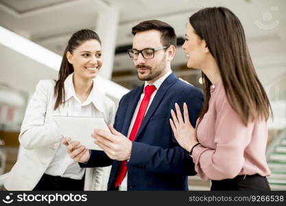 Smiling business team working with tablet pcs in office