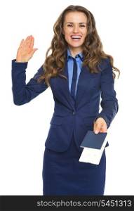 Smiling business woman giving passport with air tickets and goodbye