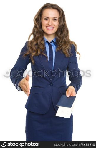 Smiling business woman giving passport with air tickets and stretching hand for handshake