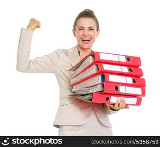 Smiling business woman holding stack of folders and showing biceps