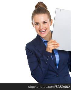 Smiling business woman looking out from folder