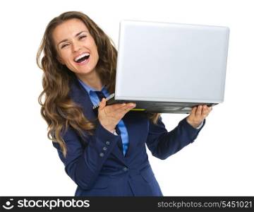 Smiling business woman looking out from laptop
