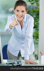 smiling business woman pointing at camera
