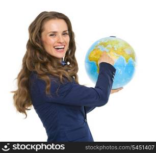Smiling business woman pointing in earth globe