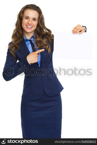 Smiling business woman pointing on blank paper sheet