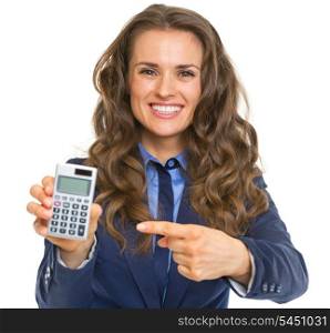 Smiling business woman pointing on calculator