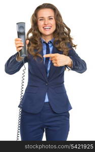 Smiling business woman pointing on phone handset