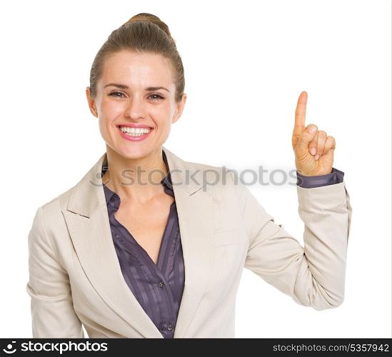 Smiling business woman pointing up on copy space