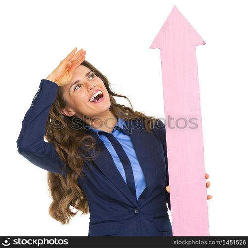 Smiling business woman pointing with arrow up and looking into distance