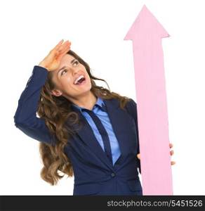 Smiling business woman pointing with arrow up and looking into distance