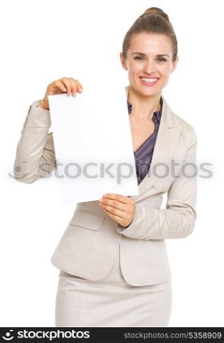 Smiling business woman showing blank paper sheet