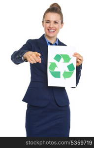 Smiling business woman showing recycle sign and pointing in camera