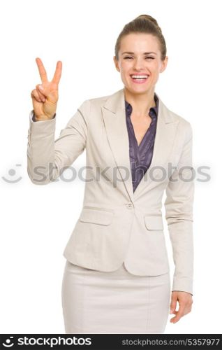 Smiling business woman showing victory gesture