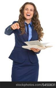 Smiling business woman with book pointing in camera