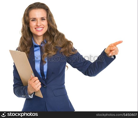 Smiling business woman with clipboard pointing on copy space