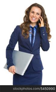 Smiling business woman with laptop talking cell phone