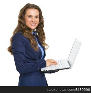 Smiling business woman working on laptop