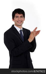 Smiling businessman clapping his hands