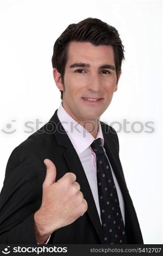 Smiling businessman giving the thumb&rsquo;s up