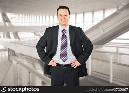 smiling businessman in glass hall