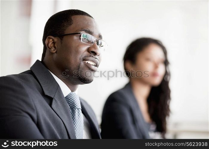 Smiling businessman listening at a business meeting