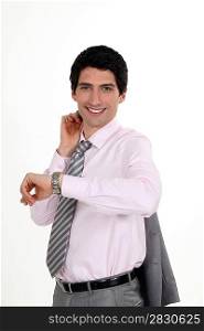 Smiling businessman looking at his watch