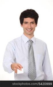 Smiling businessman offering his business card