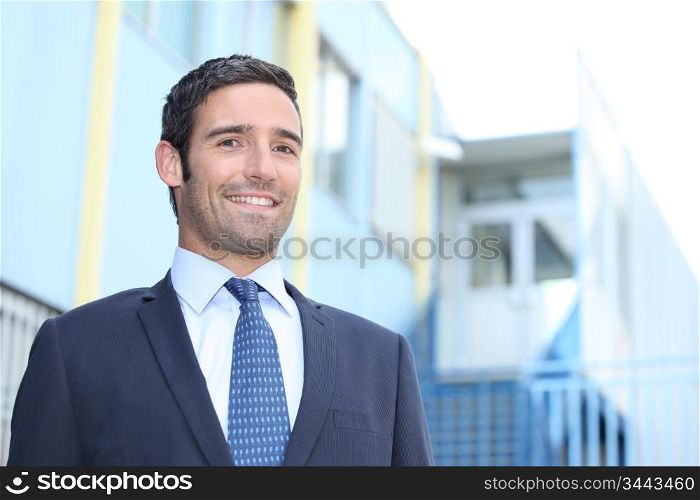 Smiling businessman outside a building