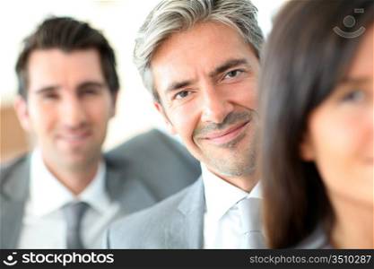 Smiling businessman standing amongst group
