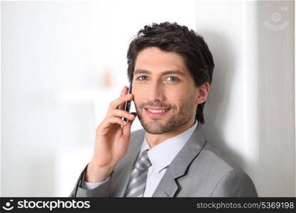 Smiling businessman using a cellphone