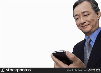 Smiling businessman using cell phone over white background