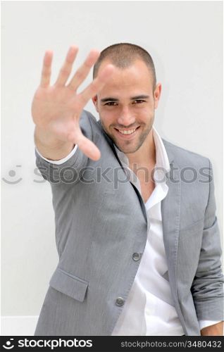 Smiling businessman with hand on foreground
