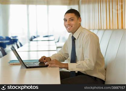 Smiling businessman with laptop