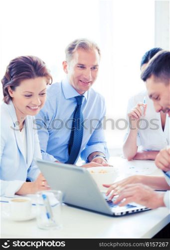 smiling businessman with team on meeting in office. businessman with team on meeting in office