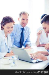 smiling businessman with team on meeting in office. businessman with team on meeting in office