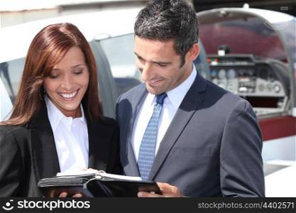 Smiling businesspeople reading notes
