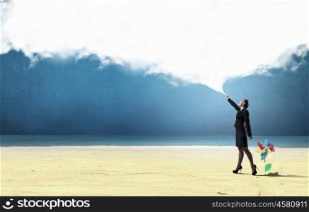 Smiling businesswoman carrying big cloud in hands