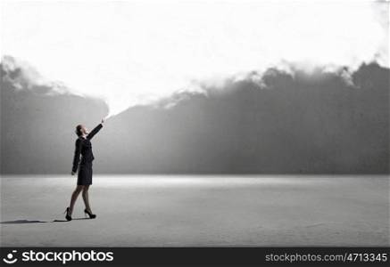 Smiling businesswoman carrying big cloud in hands