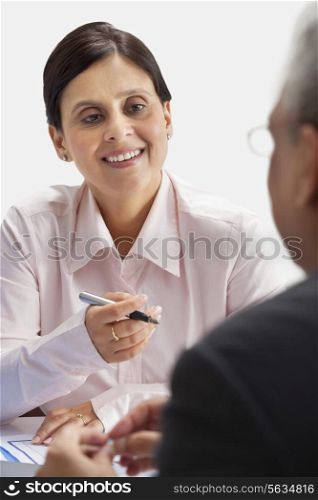 Smiling businesswoman having conversation with man