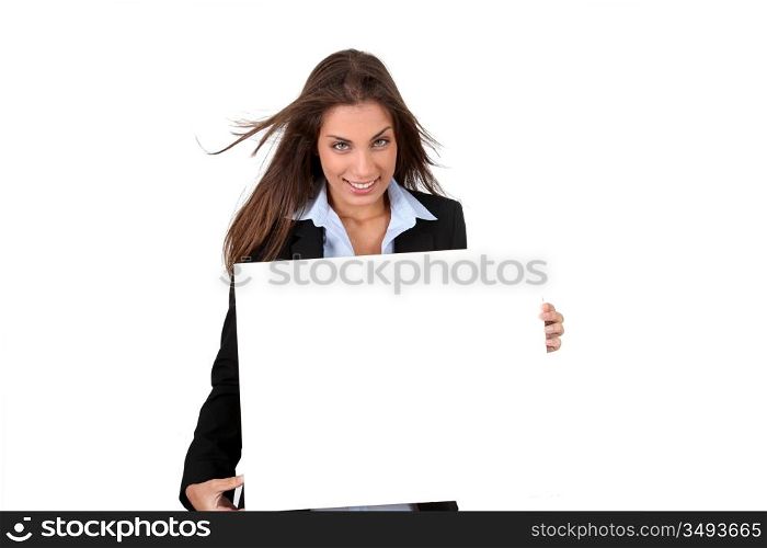 Smiling businesswoman holding whiteboard