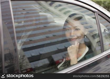 Smiling Businesswoman in Car Back