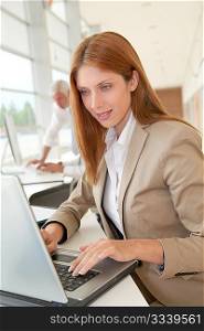 Smiling businesswoman in front of laptop