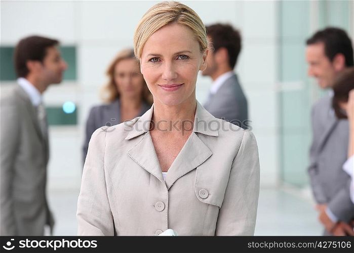 Smiling businesswoman outside with her team