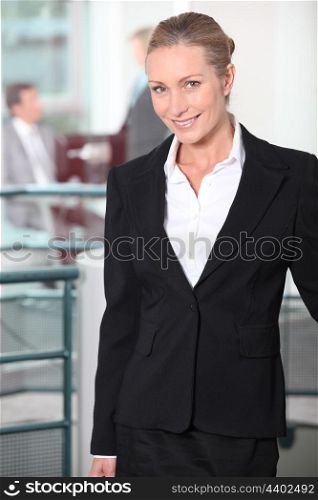 Smiling businesswoman standing in an office