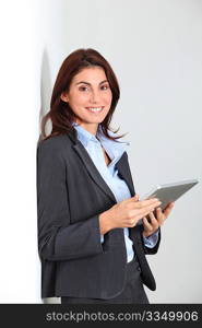 Smiling businesswoman using electronic tab