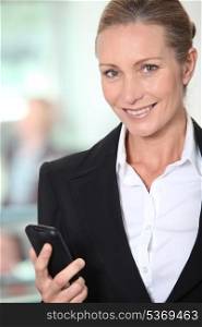 Smiling businesswoman with an office background