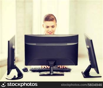 smiling businesswoman with computer and monitors in office
