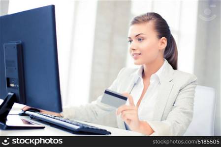 smiling businesswoman with computer using credit card. businesswoman with laptop using credit card