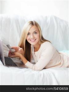 smiling businesswoman with laptop and credit card